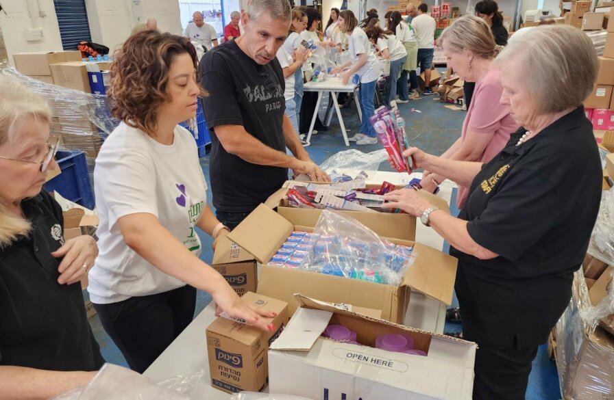 ICEJ staff packing food and supply boxes.