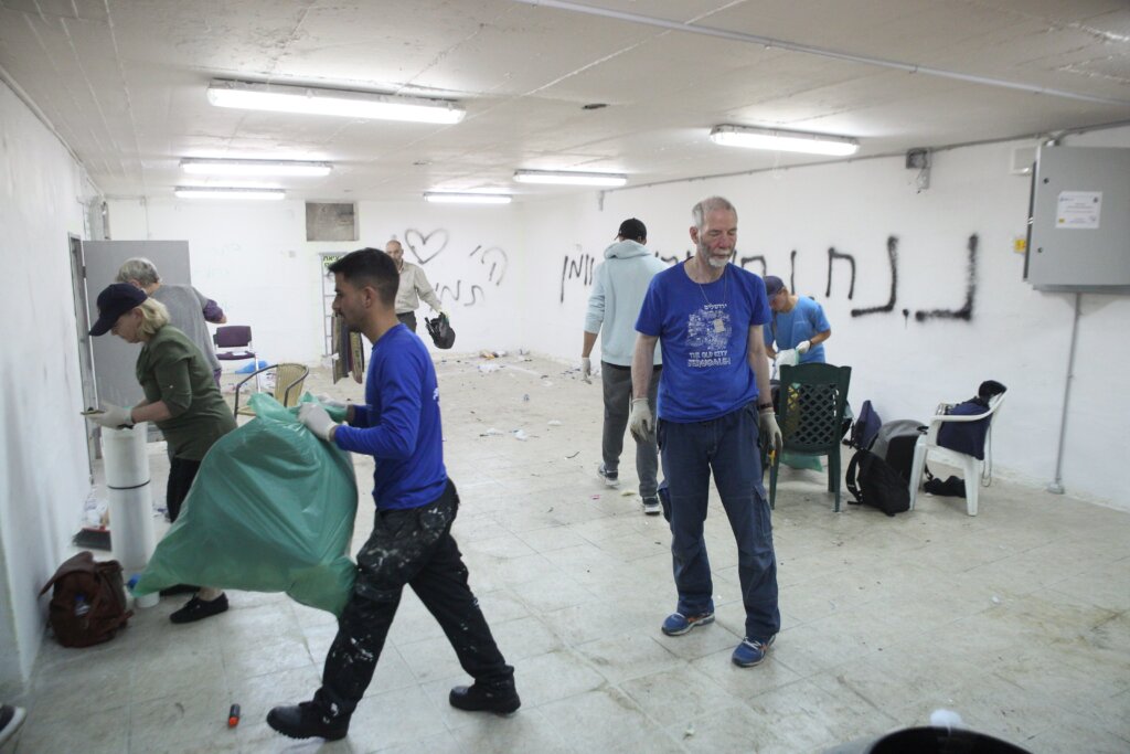 Christian volunteers renovate a bomb shelter during an ICEJ Hands-On Tour