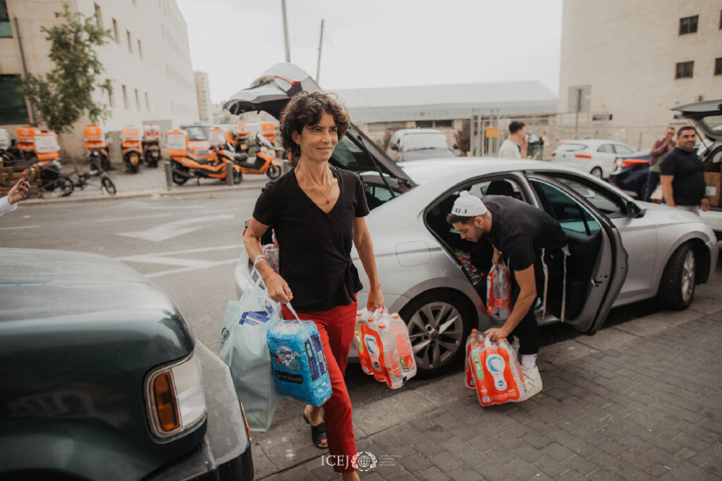 ICEJ staff distributing food and water.